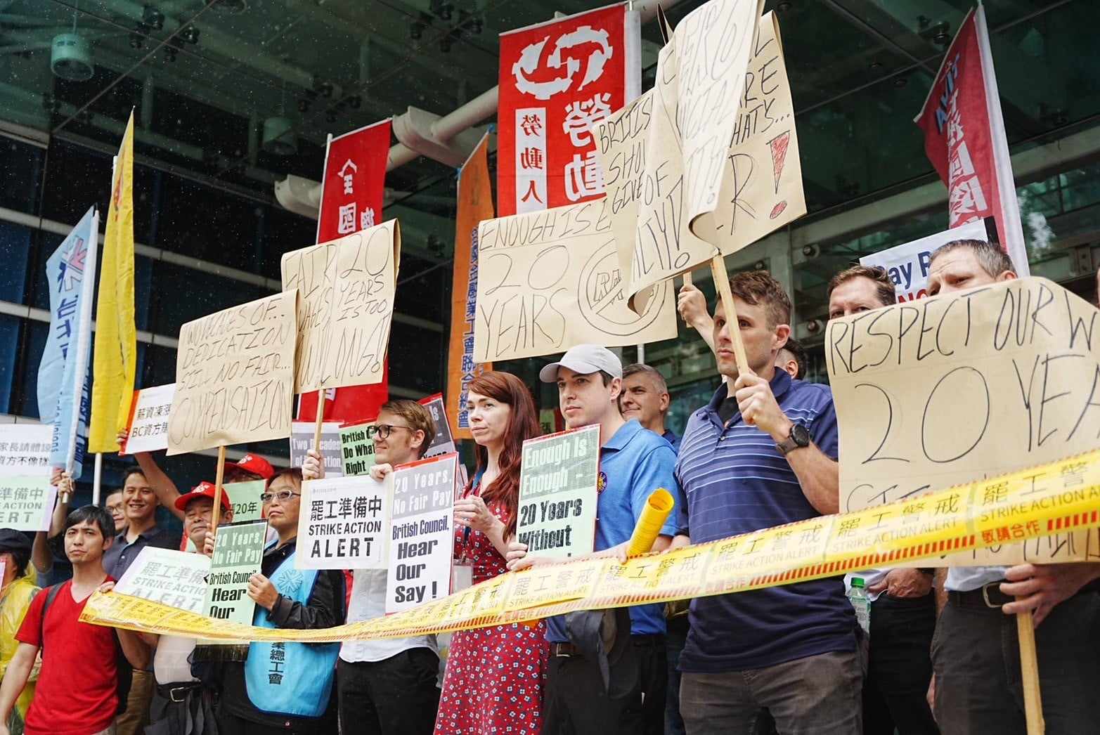 Image shows a group of workers and supporter out BC Taiwan with signs in English and Chinese